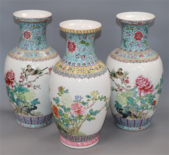 A pair of Chinese famille rose vases and another similar (3) Height 36cm